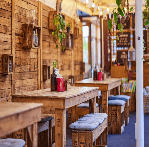 Cosy hotel café with rustic wooden décor and inviting seating for guests to enjoy relaxed dining.