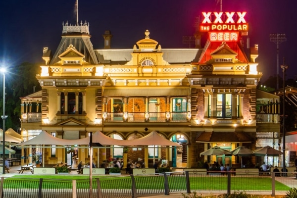 The front of Breakfast Creek Hotel illuminated against the night sky, Brisbane, Australia