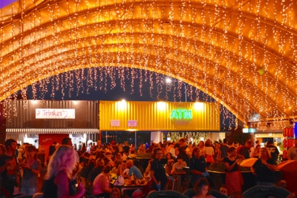 Night scene at Eat Street Northshore, with people enjoying food and entertainment in Brisbane, Australia