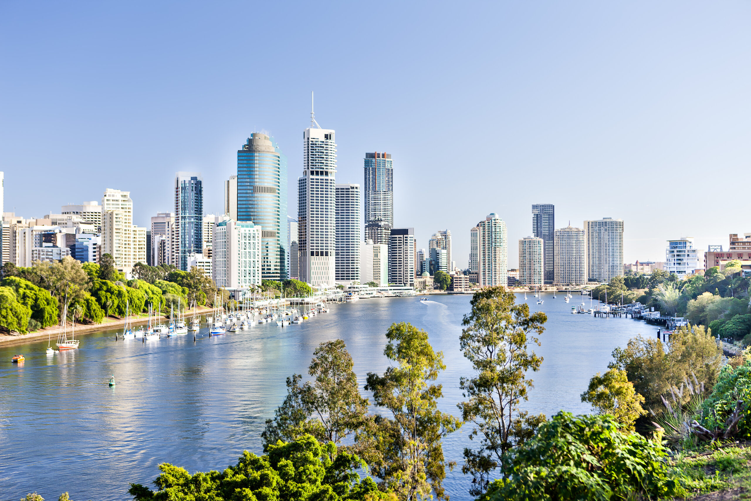 Stunning river view of city skyline with lush greenery, ideal location for your relaxing urban getaway.