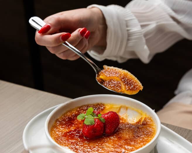 Creme Brulee with a spoonful ready to take a bite.