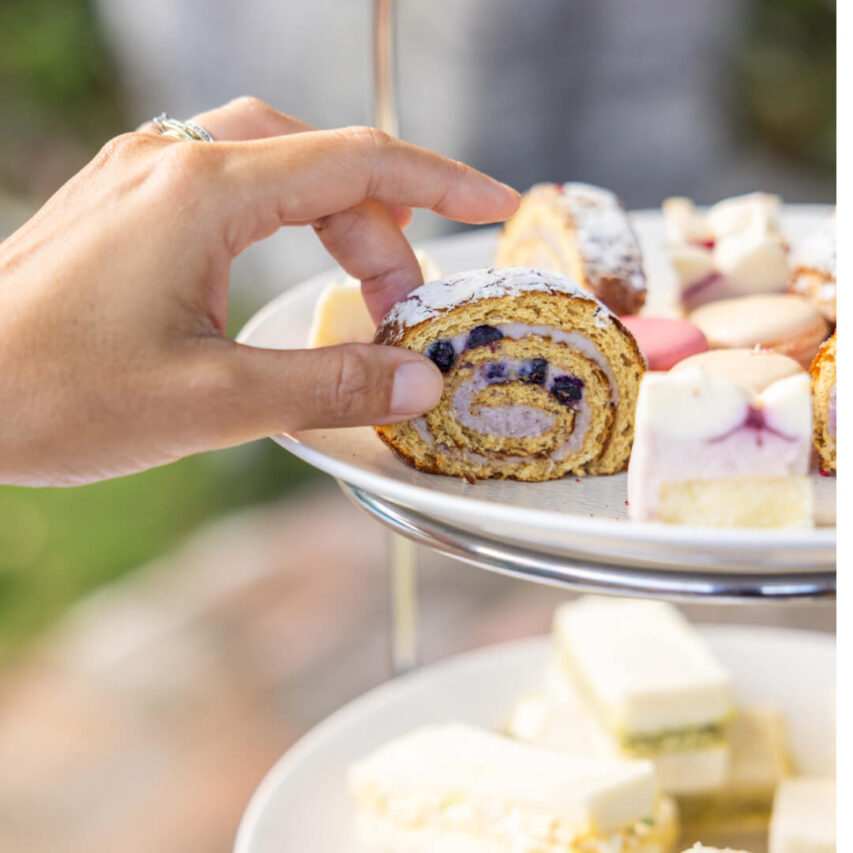 Mothers day high tea woman selecting a cake