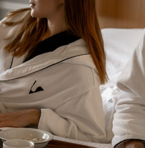 Image depicting a cozy winter scene, with snow-covered trees, a cabin, and a glowing light from the window, creating a warm, inviting atmosphere.