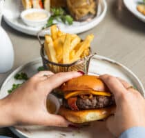 VIEW WAGYU BURGER - Wagyu patty, bacon, American cheese, house-made burger sauce, pickles and French fries.