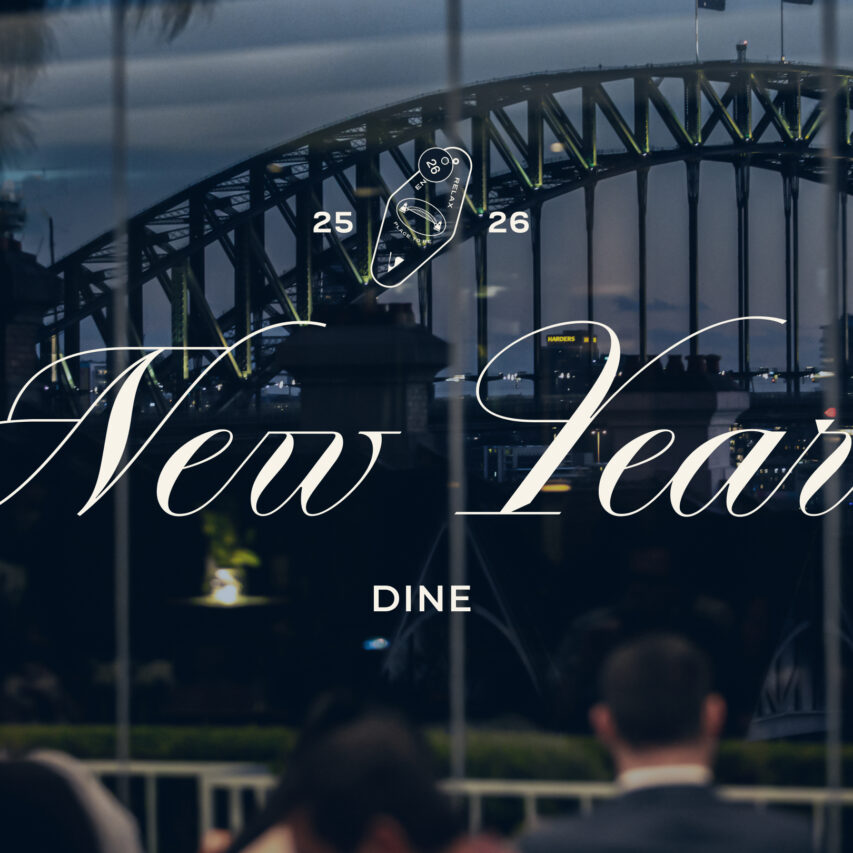 A stunning view of a city skyline at night with vibrant fireworks lighting up the sky, reflecting on the water below. Perfect setting for a New Year's celebration.