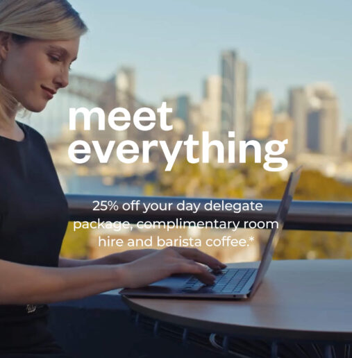 Woman on laptop at View Sydney looking over Sydney Harbour