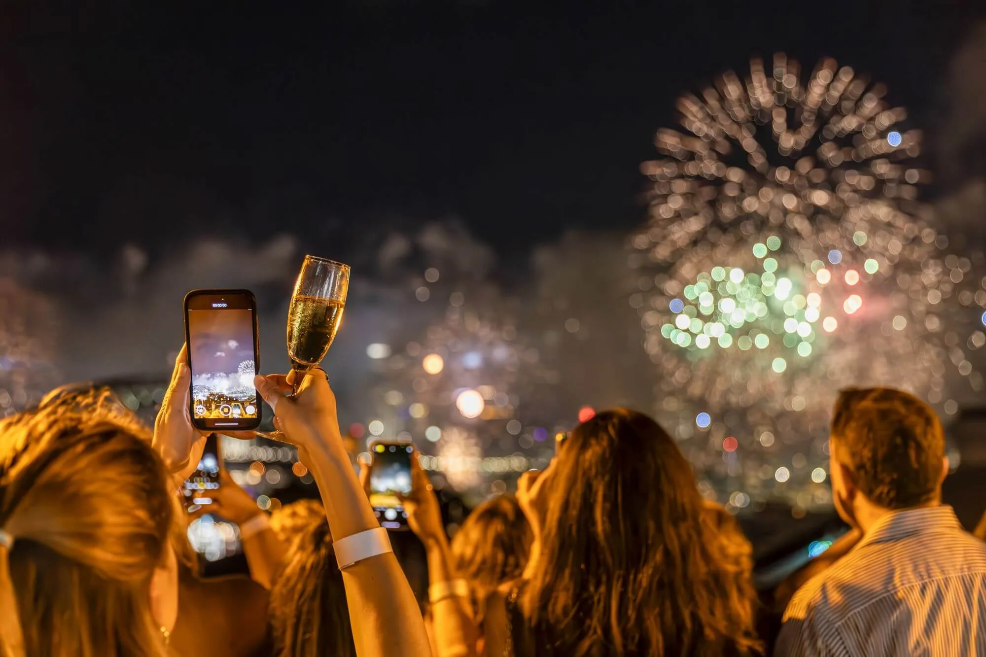 Guests on the terrace as the midnight fireworks fill the sky